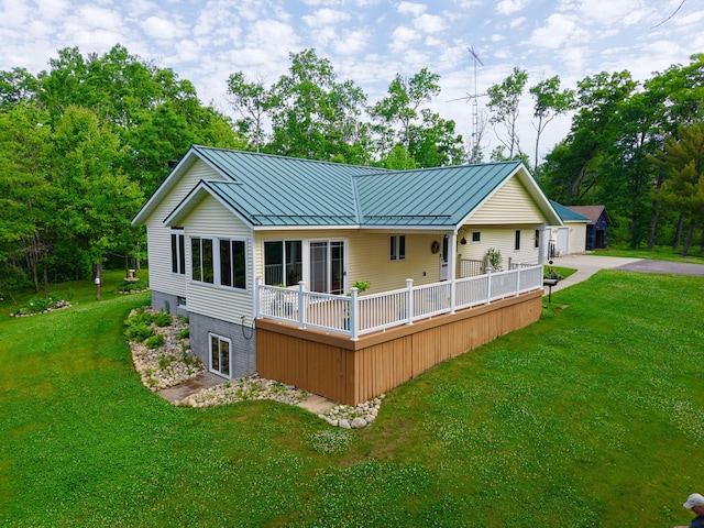 870 Dalton Dr, Rose City, MI 48654 - back of house featuring a standing seam roof, a lawn, and a metal roof
