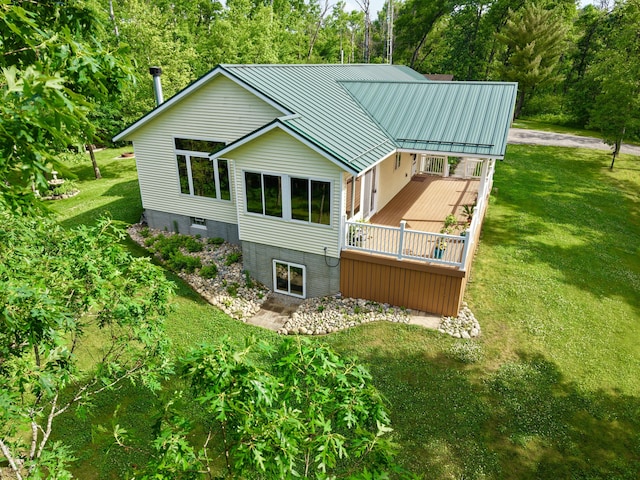 870 Dalton Dr, Rose City, MI 48654 - rear view of house with a yard, a wooden deck, a metal roof, and a standing seam roof
