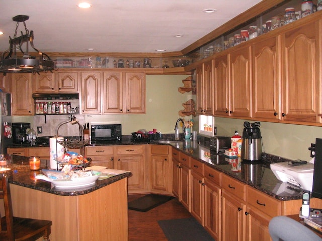 5198 Troopers Trl, Frederic, MI 49733 - kitchen featuring black appliances, a sink, dark stone counters, a kitchen breakfast bar, and dark wood-style floors