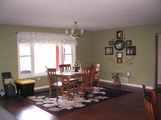 5198 Troopers Trl, Frederic, MI 49733 - dining room featuring wood finished floors, a chandelier, and baseboards