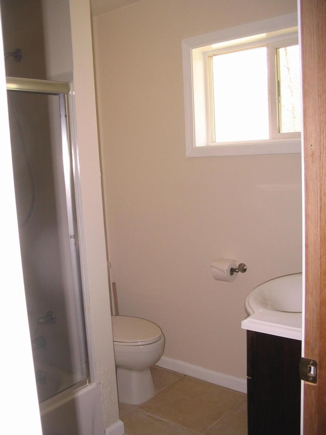 5198 Troopers Trl, Frederic, MI 49733 - bathroom featuring toilet, tile patterned floors, bath / shower combo with glass door, baseboards, and vanity
