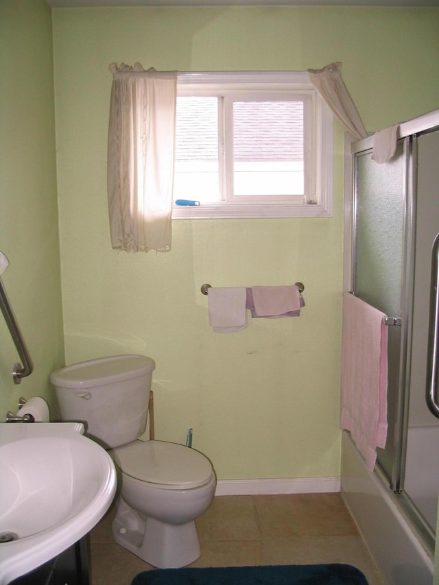 5198 Troopers Trl, Frederic, MI 49733 - full bathroom with toilet, tile patterned floors, baseboards, a sink, and enclosed tub / shower combo