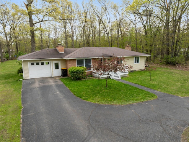 6727 Fisher Woods Rd, Indian River, MI 49749 - single story home featuring an attached garage, a chimney, driveway, and a front lawn