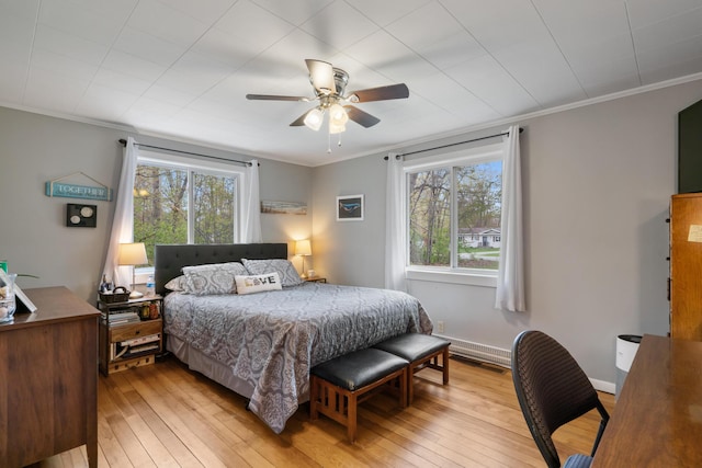 6727 Fisher Woods Rd, Indian River, MI 49749 - bedroom featuring multiple windows, light wood-style flooring, crown molding, and ceiling fan