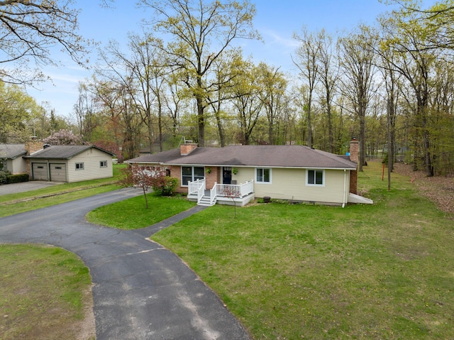 6727 Fisher Woods Rd, Indian River, MI 49749 - ranch-style home featuring a chimney, covered porch, a front lawn, and a garage