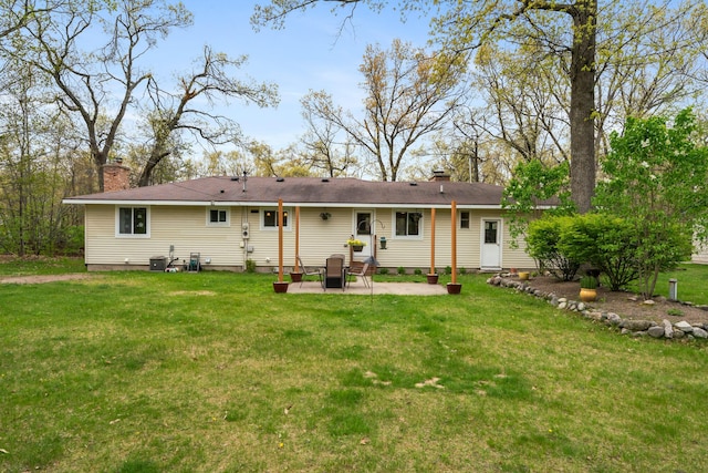 6727 Fisher Woods Rd, Indian River, MI 49749 - back of property featuring a patio area, a chimney, a yard, and central AC