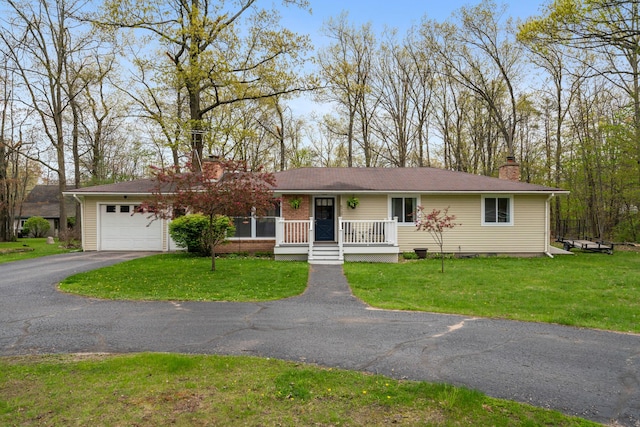 6727 Fisher Woods Rd, Indian River, MI 49749 - single story home featuring a chimney, a garage, driveway, and a front lawn