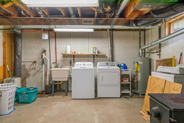 6727 Fisher Woods Rd, Indian River, MI 49749 - below grade area with gas water heater, separate washer and dryer, concrete block wall, and a sink