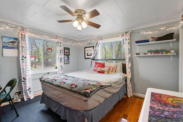 6727 Fisher Woods Rd, Indian River, MI 49749 - bedroom with ornamental molding, ceiling fan, and hardwood / wood-style floors