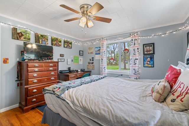 6727 Fisher Woods Rd, Indian River, MI 49749 - bedroom with light wood finished floors, crown molding, a ceiling fan, and baseboards