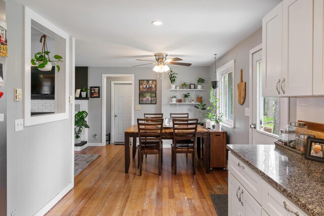 6727 Fisher Woods Rd, Indian River, MI 49749 - dining room featuring a ceiling fan, light wood-style flooring, and baseboards