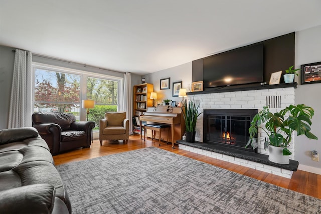 6727 Fisher Woods Rd, Indian River, MI 49749 - living area with a fireplace and wood finished floors