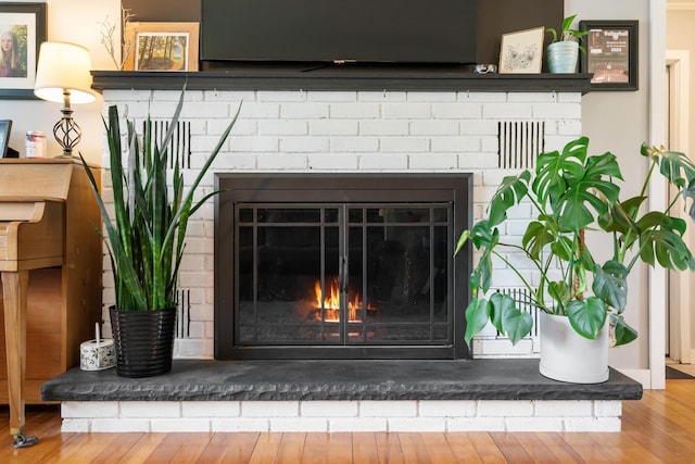 6727 Fisher Woods Rd, Indian River, MI 49749 - detailed view of a fireplace and wood finished floors