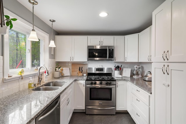 6727 Fisher Woods Rd, Indian River, MI 49749 - kitchen with appliances with stainless steel finishes, a sink, white cabinets, tasteful backsplash, and recessed lighting