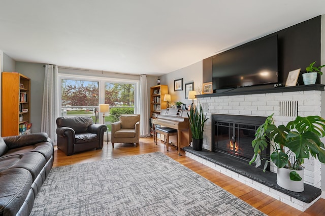 6727 Fisher Woods Rd, Indian River, MI 49749 - living room featuring a fireplace and wood finished floors