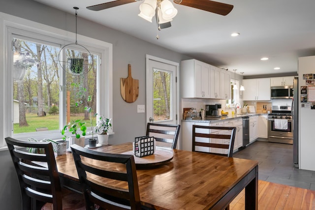 6727 Fisher Woods Rd, Indian River, MI 49749 - dining area with plenty of natural light, ceiling fan, recessed lighting, and wood finished floors