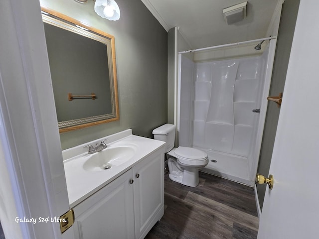 72 Chelsey Ln, Cheboygan, MI 49721 - full bathroom with wood finished floors, vanity, a shower, toilet, and ornamental molding