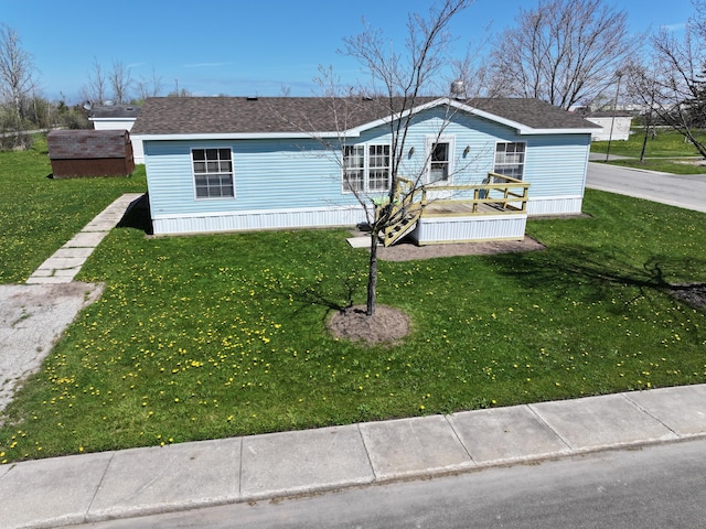 72 Chelsey Ln, Cheboygan, MI 49721 - manufactured / mobile home featuring a front lawn and roof with shingles