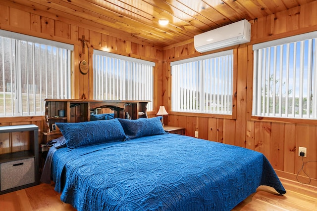 2286 Maxwell Rd, Petoskey, MI 49770 - bedroom with an AC wall unit, wood finished floors, and wood walls