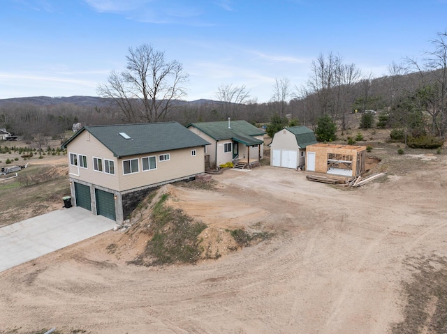 2286 Maxwell Rd, Petoskey, MI 49770 - view of front facade with a garage, a storage shed, driveway, and an outdoor structure