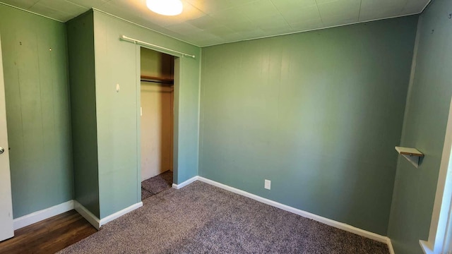 6131 N F41, Spruce, MI 48762 - unfurnished bedroom featuring a closet and dark colored carpet