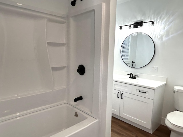 1033 S First Ave, Alpena, MI 49707 - bathroom with toilet, wood finished floors, vanity, and tub / shower combination