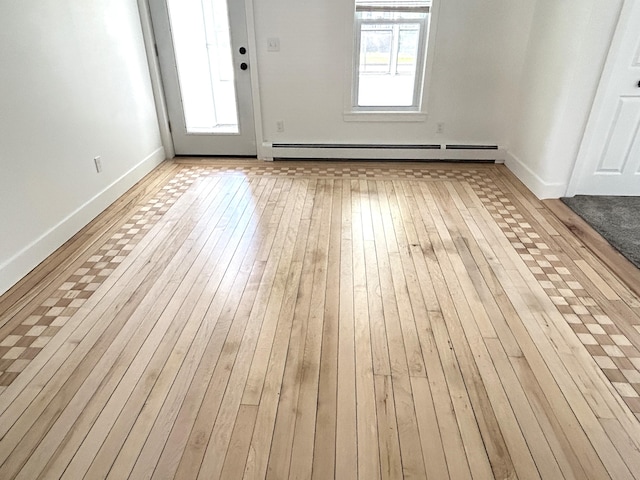1033 S First Ave, Alpena, MI 49707 - foyer with wood-type flooring, baseboards, and a baseboard radiator