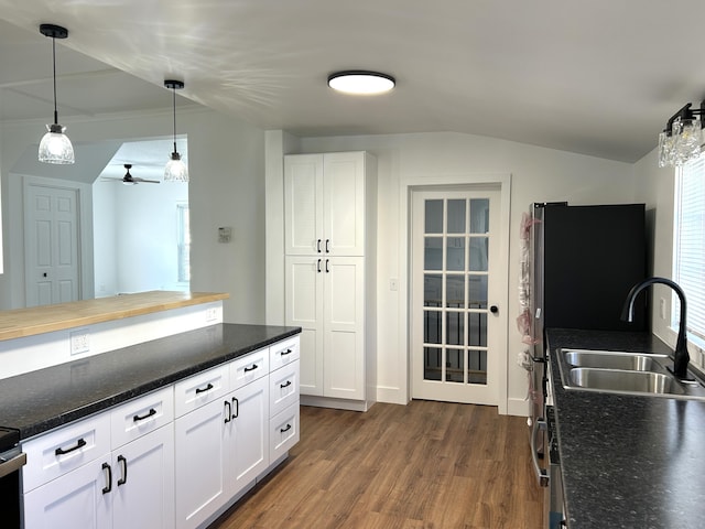 1033 S First Ave, Alpena, MI 49707 - kitchen featuring a sink, dark wood-style floors, white cabinetry, decorative light fixtures, and vaulted ceiling