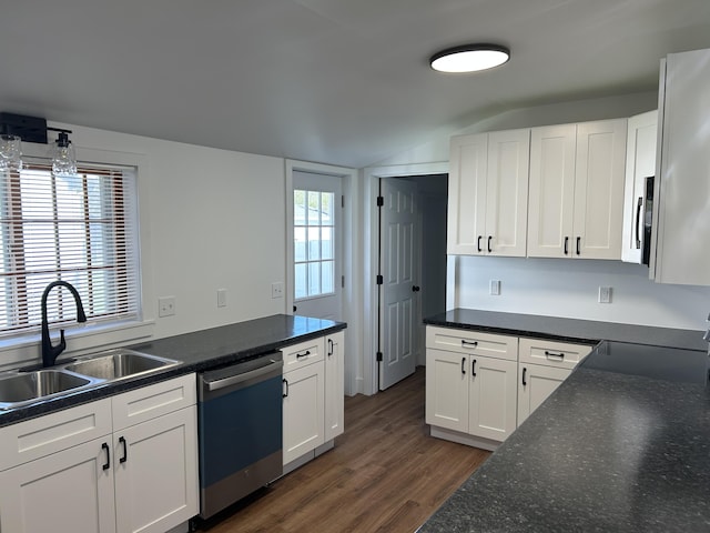 1033 S First Ave, Alpena, MI 49707 - kitchen featuring dishwasher, a sink, vaulted ceiling, dark wood-style floors, and white cabinetry