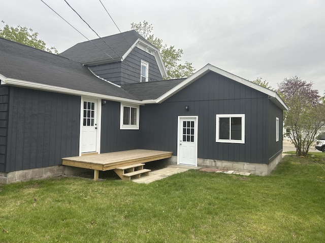 1033 S First Ave, Alpena, MI 49707 - rear view of house with a wooden deck and a lawn