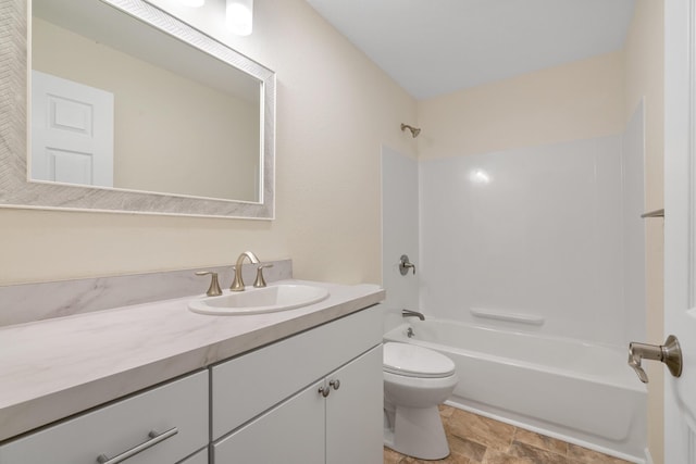 2067 Woods Ln, Petoskey, MI 49770 - bathroom with toilet, washtub / shower combination, vanity, and stone finish flooring