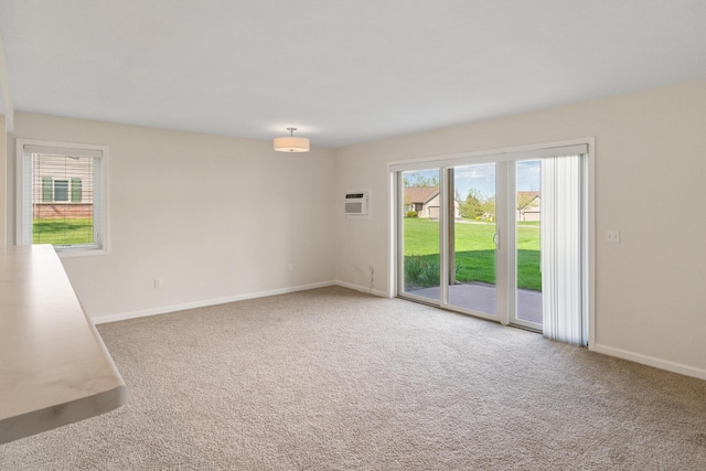 2067 Woods Ln, Petoskey, MI 49770 - carpeted spare room featuring baseboards and a wall unit AC