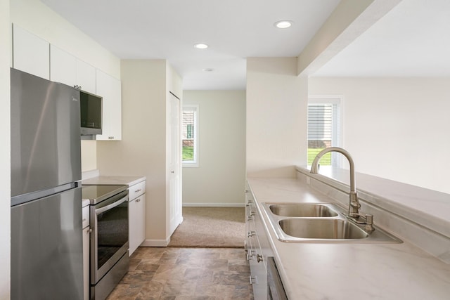 2067 Woods Ln, Petoskey, MI 49770 - kitchen featuring stainless steel appliances, a sink, healthy amount of natural light, white cabinetry, and recessed lighting