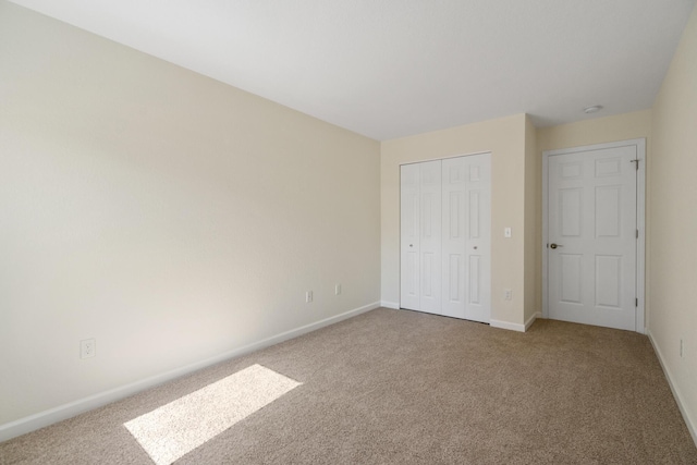2067 Woods Ln, Petoskey, MI 49770 - unfurnished bedroom featuring carpet flooring and baseboards