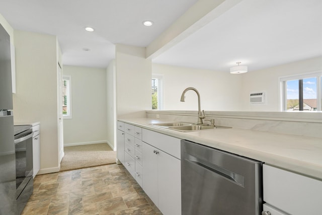 2067 Woods Ln, Petoskey, MI 49770 - kitchen with stainless steel appliances, a sink, stone finish flooring, white cabinets, and light countertops