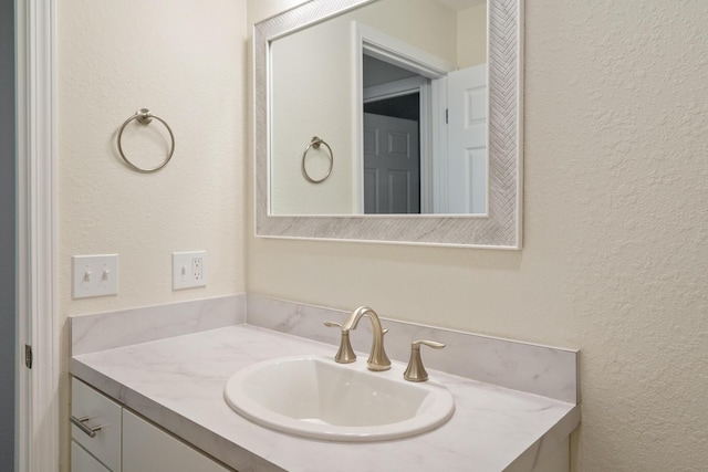 2067 Woods Ln, Petoskey, MI 49770 - bathroom featuring a textured wall and vanity