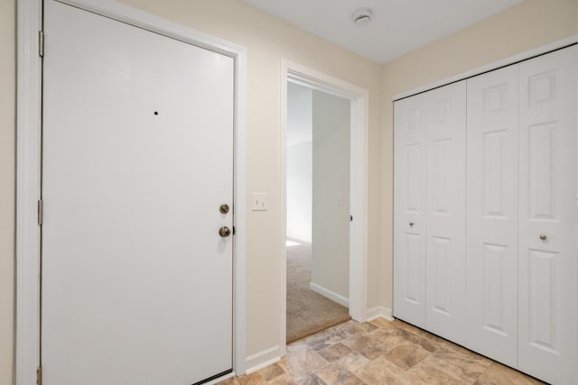 2067 Woods Ln, Petoskey, MI 49770 - entrance foyer with baseboards and stone finish floors