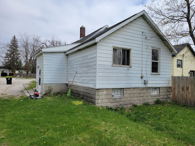 420 W Miller St, Alpena, MI 49707 - view of home's exterior with a chimney