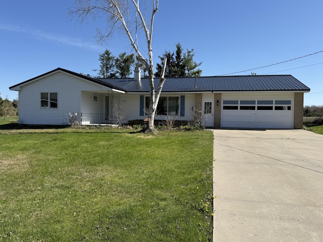 638 Snow Apple Ct, Cheboygan, MI 49721 - ranch-style house with an attached garage, driveway, a front lawn, and metal roof