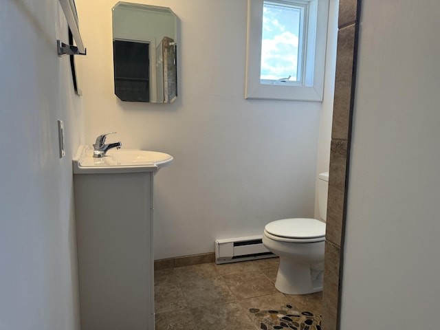 638 Snow Apple Ct, Cheboygan, MI 49721 - bathroom featuring a baseboard heating unit, toilet, vanity, and baseboards