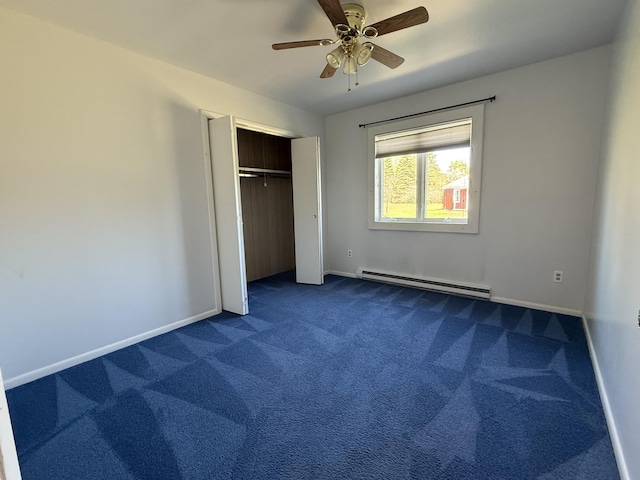 638 Snow Apple Ct, Cheboygan, MI 49721 - unfurnished bedroom featuring a baseboard radiator, dark carpet, baseboards, a closet, and ceiling fan