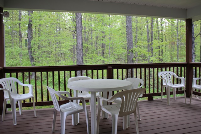 2426 W Park Rd, Mio, MI 48647 - deck featuring outdoor dining area and a forest view