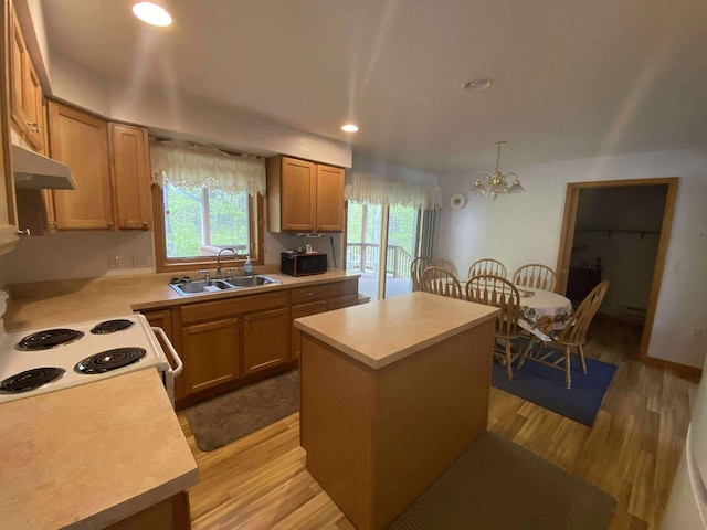 2426 W Park Rd, Mio, MI 48647 - kitchen featuring under cabinet range hood, a sink, a center island, light countertops, and recessed lighting