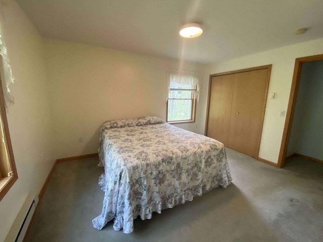 2426 W Park Rd, Mio, MI 48647 - bedroom featuring a baseboard heating unit, light colored carpet, and baseboards