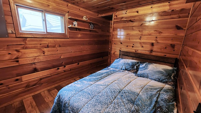 610 Old Trail Dr, Houghton Lake, MI 48629 - bedroom with wooden ceiling, wooden walls, and wood finished floors