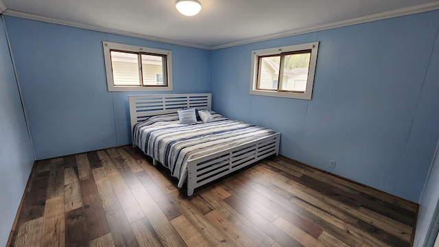 610 Old Trail Dr, Houghton Lake, MI 48629 - bedroom with ornamental molding, multiple windows, and hardwood / wood-style flooring
