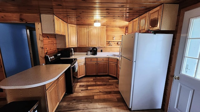 610 Old Trail Dr, Houghton Lake, MI 48629 - kitchen featuring black appliances, dark wood finished floors, light countertops, wood ceiling, and a peninsula