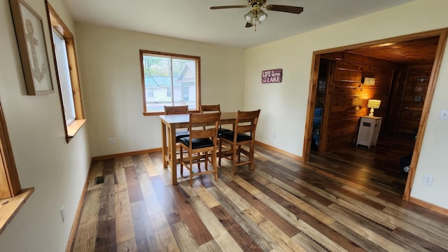 610 Old Trail Dr, Houghton Lake, MI 48629 - dining room with wood finished floors, a ceiling fan, and baseboards