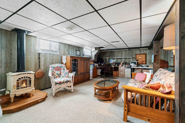 6620 N Straits Hwy, Cheboygan, MI 49721 - living room featuring a wood stove, carpet, and a paneled ceiling