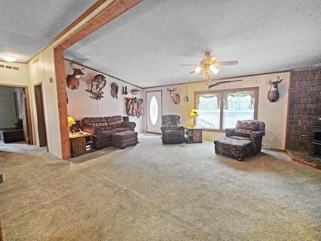 5844 Keipinger Trl, Grayling, MI 49738 - living area featuring a textured ceiling, carpet flooring, ceiling fan, crown molding, and a wood stove
